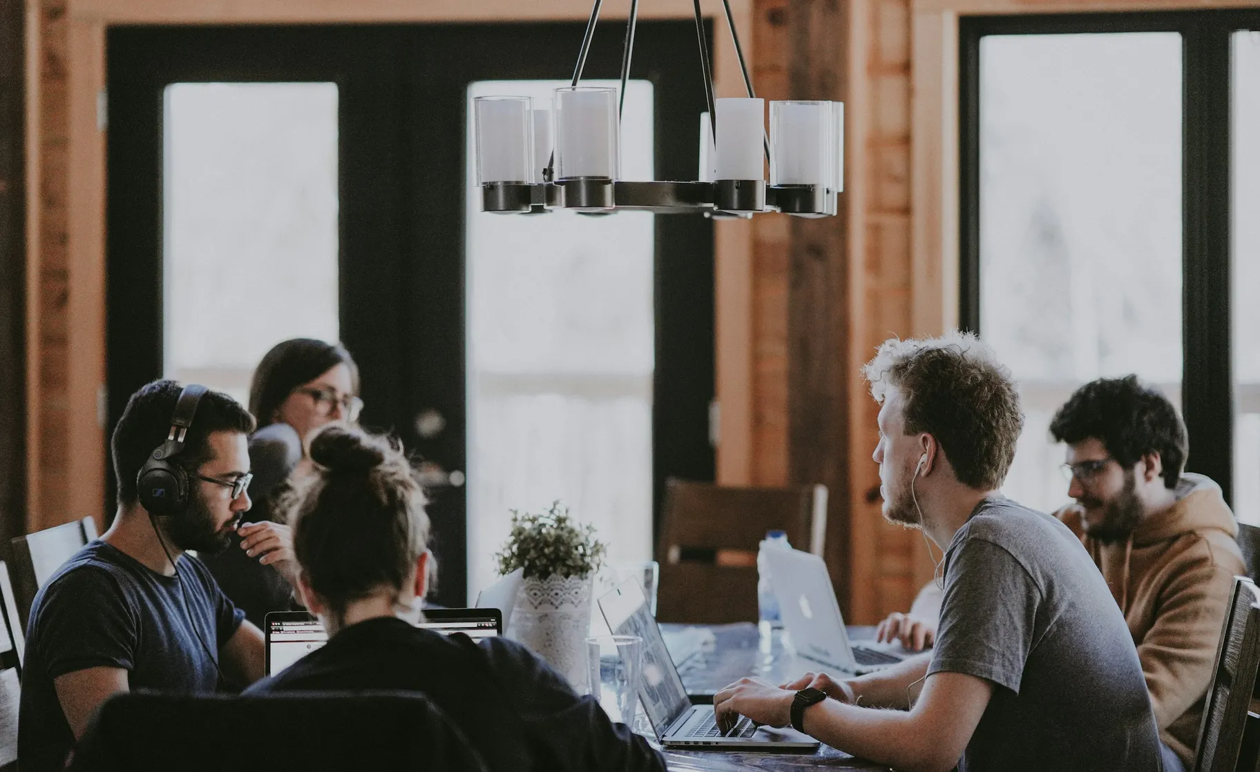 Team having a discussion around a meeting table in an office.